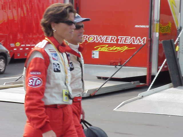 driver and friend walking towards garages.
