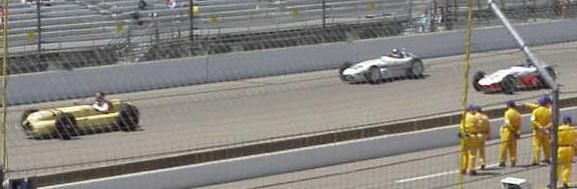 old race cars doing laps