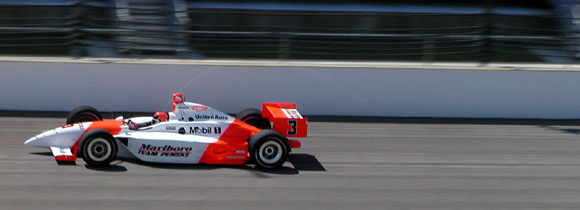 Penske car zips by